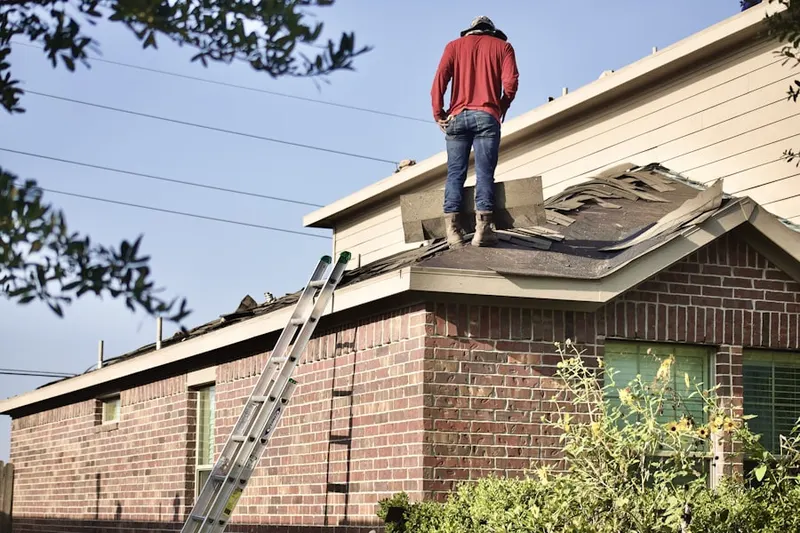 Professional roofer working on a residential roof in Central Falls